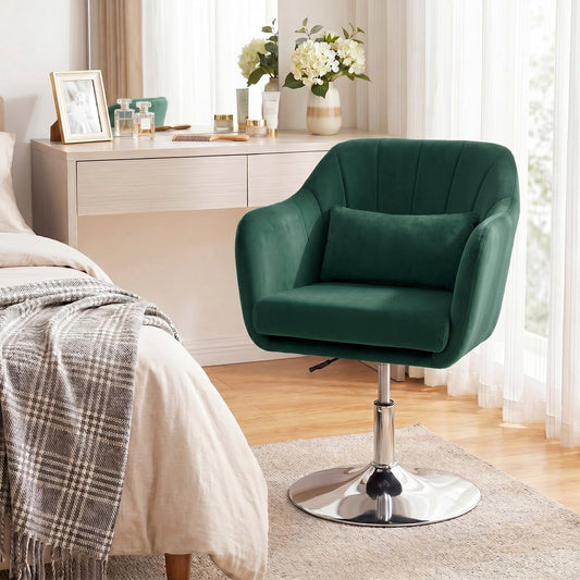 The dark green velvet tub chair is shown in a bedroom setting next to a bed and dressing table