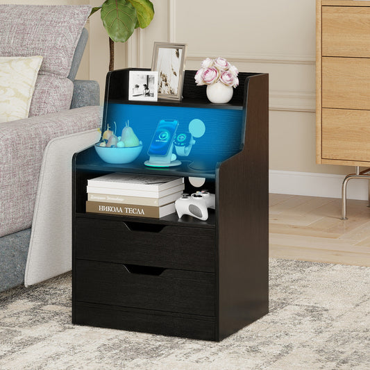 Black bedside table with open shelf, drawers and charging station in a bedroom setting