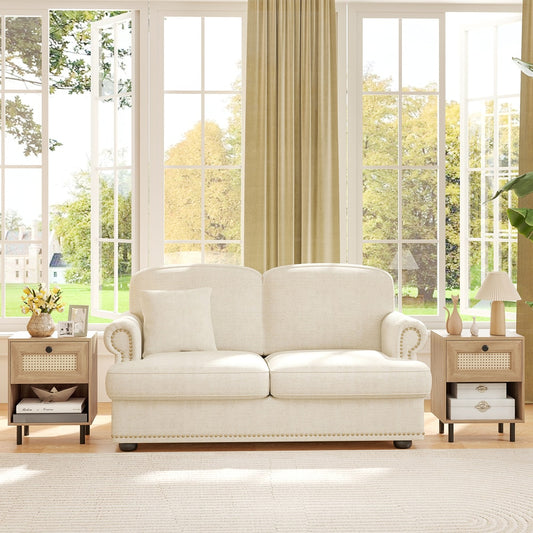 The nightstands placed on either side of a cream sofa in a bright living room