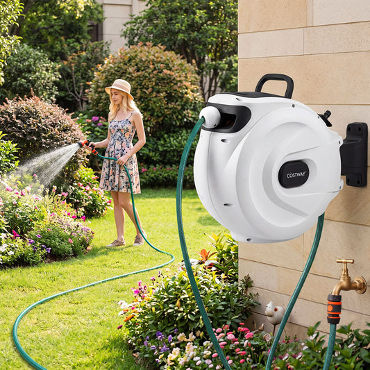 Woman using the garden hose reel to water plants in a garden