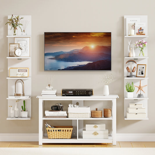 Two white vertical bookcases used for display in a living room setting