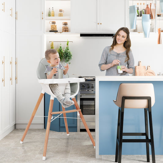 The high chair in a modern kitchen with a toddler sitting in it and a woman standing nearby