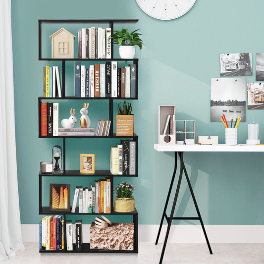the black wooden industrial bookcase standing against a light blue wall