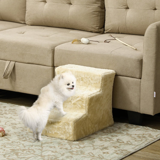 The beige three-step pet stair is placed next to a sofa, with a small dog using it to climb