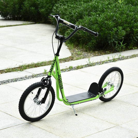 The kids scooter standing on a paved outdoor path with green bushes in the background