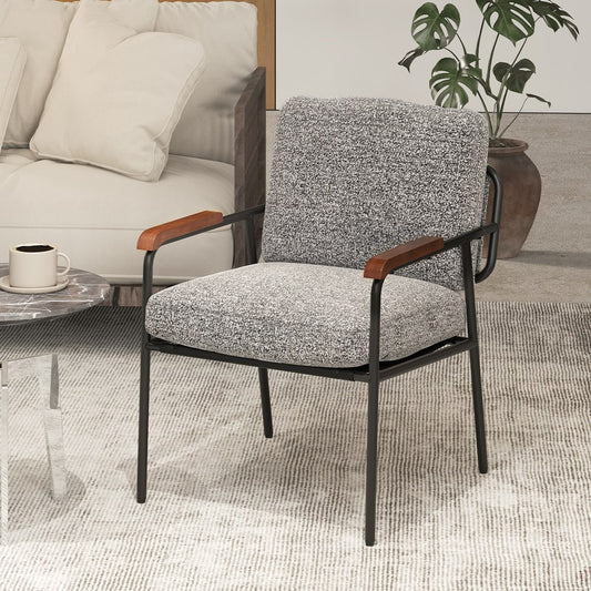 Grey fabric accent chair with back pillow and wide seat placed in a modern living room setting