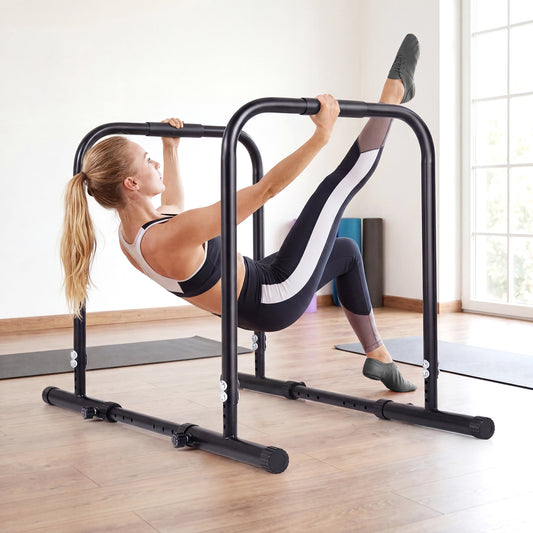 The dip station is shown in use by a woman performing a leg raise exercise in a home gym setting