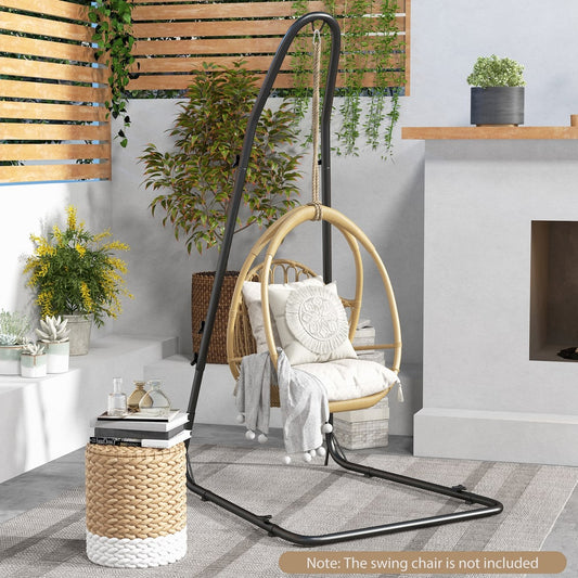 The hammock chair stand in a garden setting with a rattan chair hanging from it