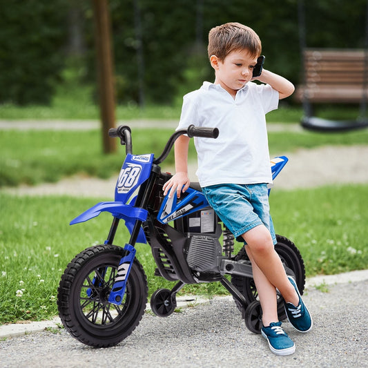 A young boy in blue shorts and white t-shirt leaning on the kids electric motorbike