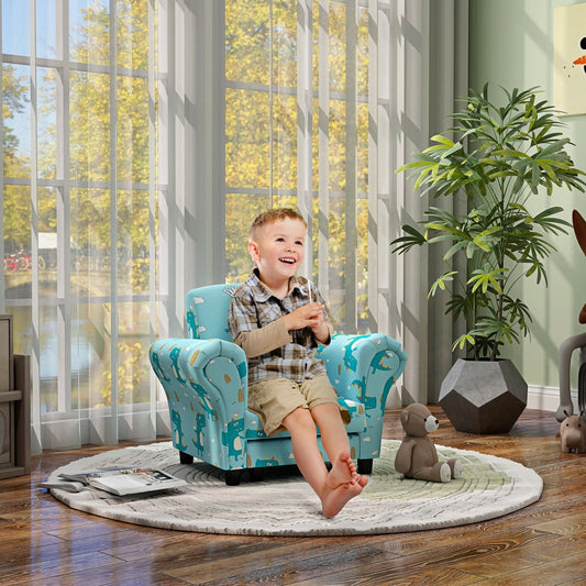 A happy young boy sitting on a blue kids sofa set with a dinosaur design