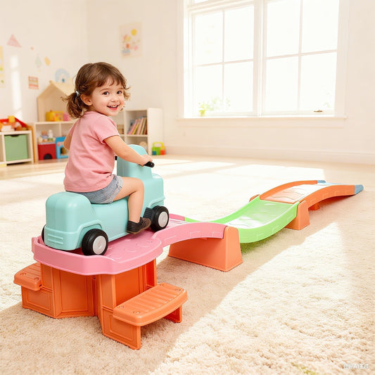 A young girl sitting on the ride-on car at the top of the colourful plastic roller coaster track