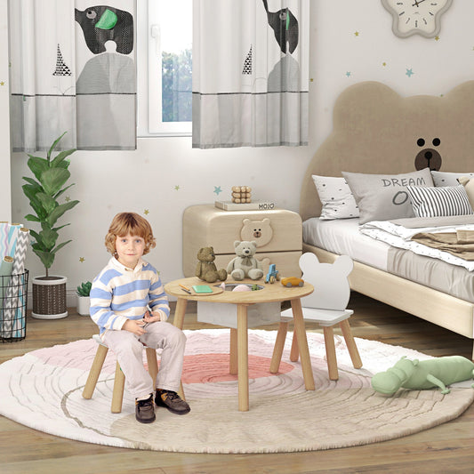 A young boy sits at the kids activity table set in a nursery room