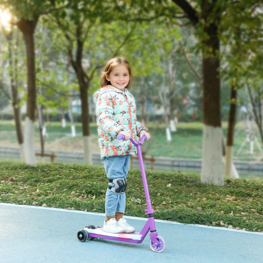 A young girl wearing a patterned jacket riding the kids scooter on a paved park path