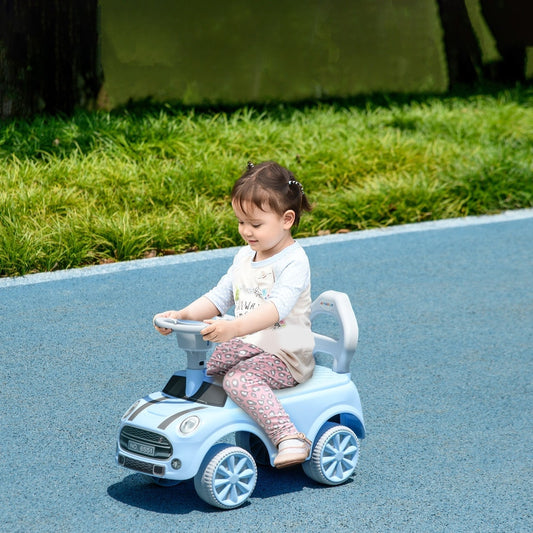 The ride on car being used by a young child on a blue outdoor path