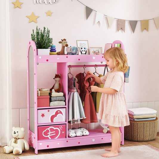 A young girl is putting clothes on the hanging rail of the pink kids wardrobe in a bedroom