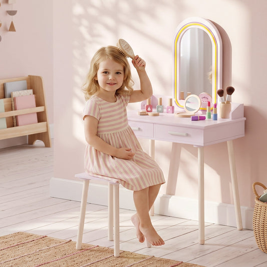 A young girl with a brush in her hair sitting at the dressing table