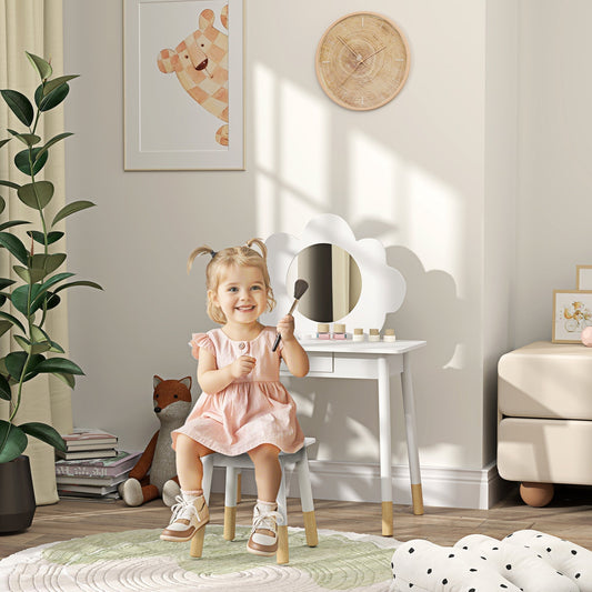 A young girl sits at the kids dressing table with mirror, playing with makeup