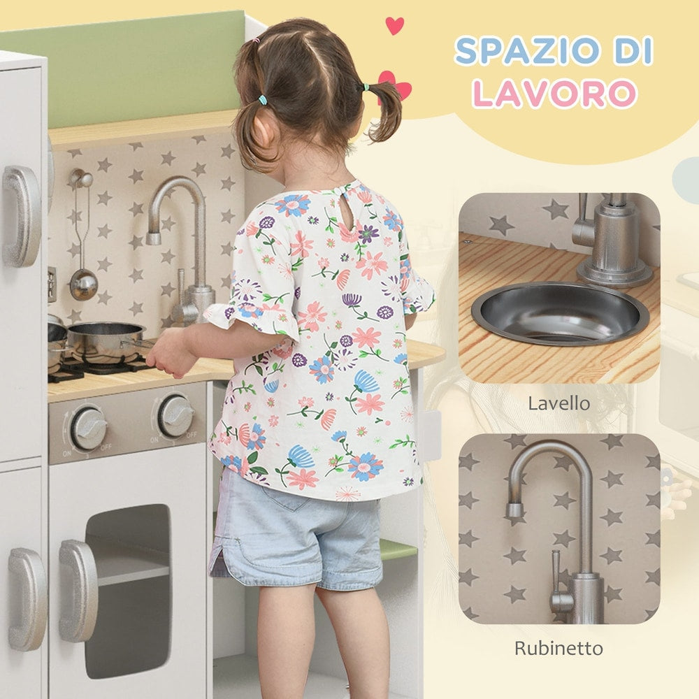 A young child plays at the white role play toy kitchen, interacting with the sink and tap