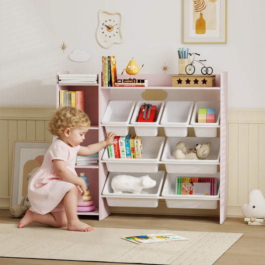 A young child plays with a pink toy storage unit filled with toys and books