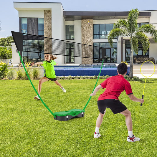 The badminton net set with green base and black net standing on a green lawn