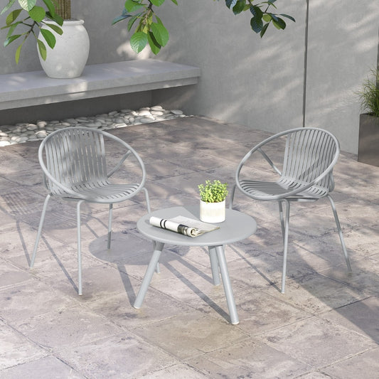 This patio furniture set is shown on a paved patio with a concrete bench behind
