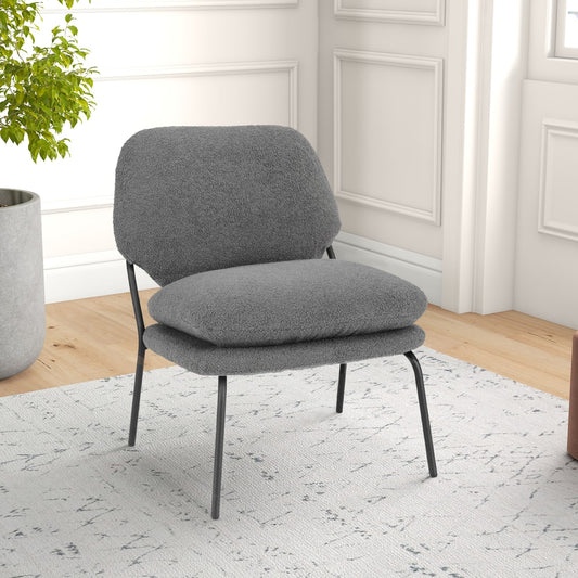 The accent chair placed on a patterned rug in a bright room with a potted plant nearby