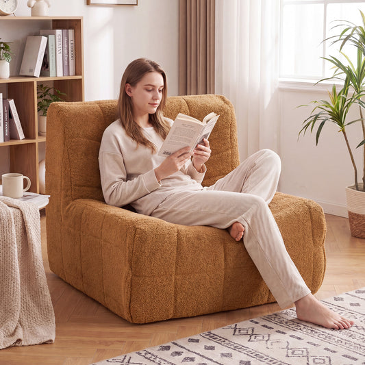 Woman reading a book while sitting on the rustic brown floor sofa in a living room