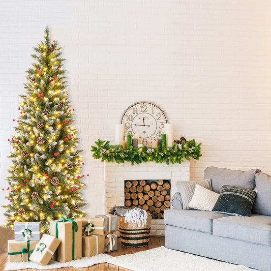 The Christmas tree standing in a living room next to a fireplace and sofa with gifts