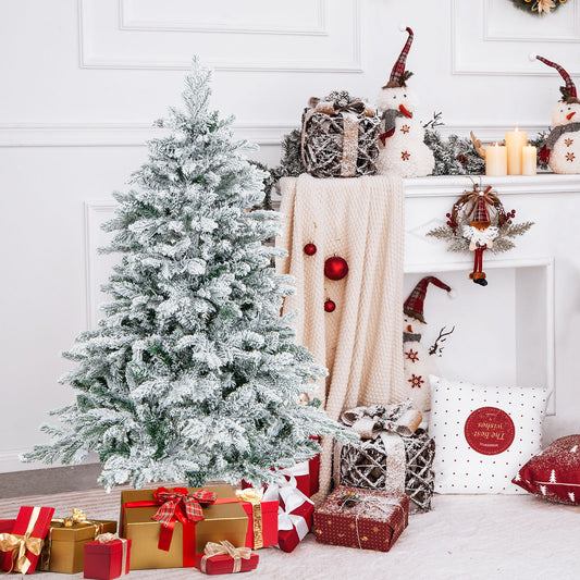 The flocked Christmas tree is decorated in a cosy room with presents and snowmen