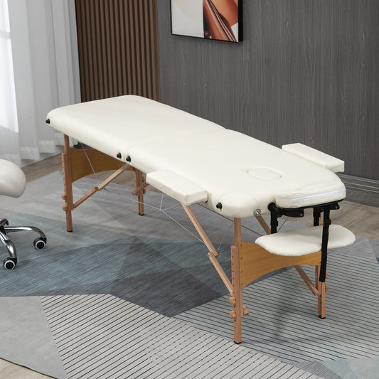 The portable massage bed is set up in a room with a chair and a rug