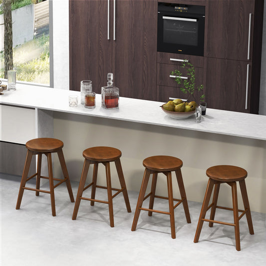 Four wooden swivel counter height bar chairs arranged at a kitchen island counter