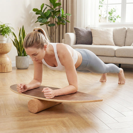 The sport equipment being used by a woman performing a plank exercise in a living room