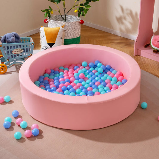 The pink foam ball pit filled with blue and pink ocean balls, placed in a nursery room