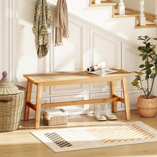 The shoe rack bench in a hallway with a basket, shoes, and a plant