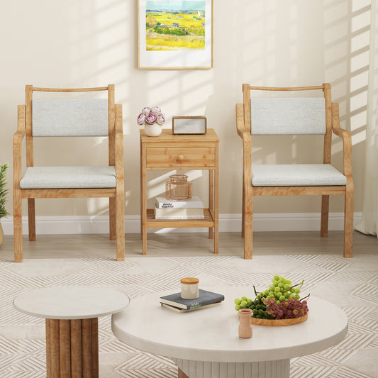 The nightstand placed between two wooden chairs in a bright living area