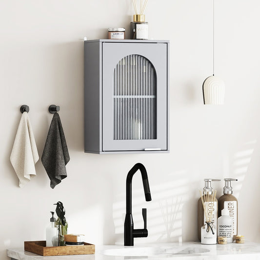 Grey wall cabinet mounted above a bathroom sink with towels and soap dispensers