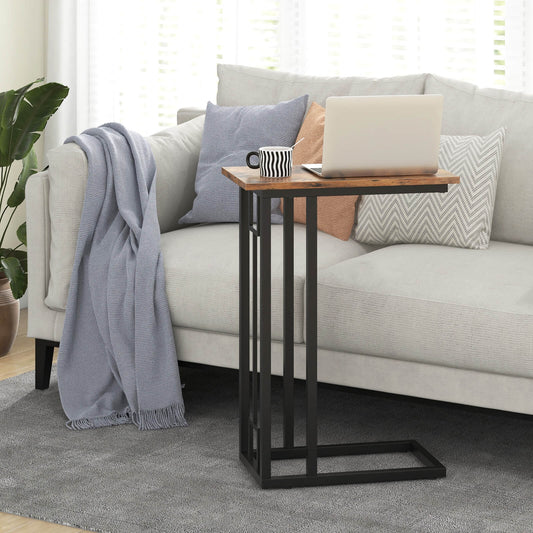 The side table placed next to a sofa with a laptop and a mug on the wooden surface