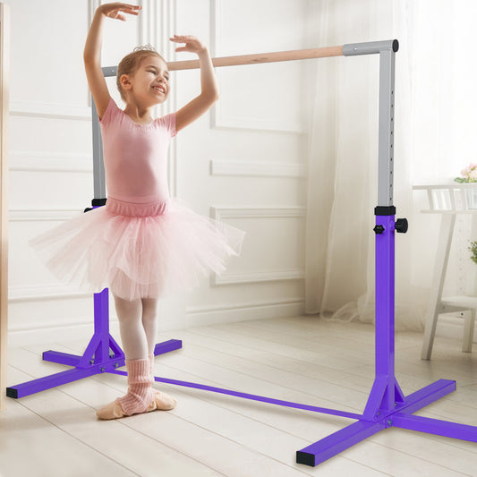 The purple gymnastics training bar with a young girl in a tutu practising ballet