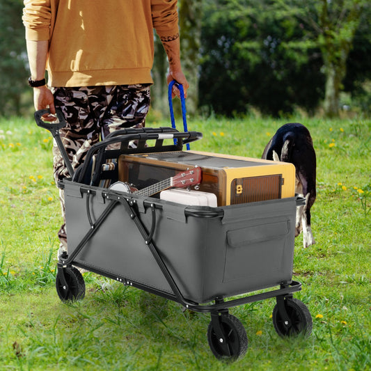 The garden cart being pulled across a grassy field with a dog walking alongside