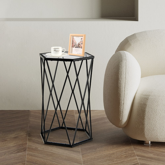 The end table is placed next to a cream armchair on a wooden floor