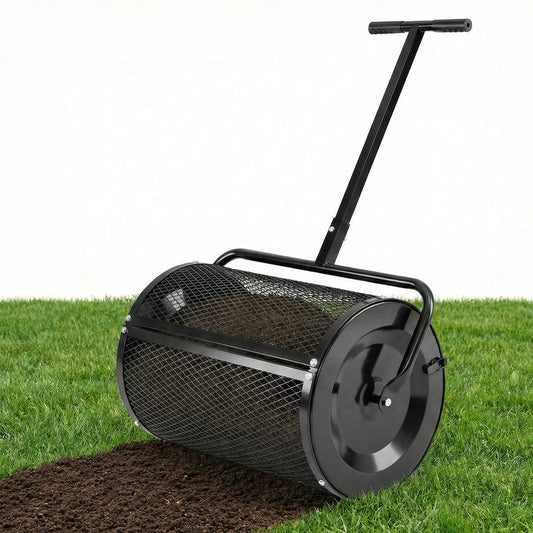 The peat moss spreader roller on a lawn with soil being spread