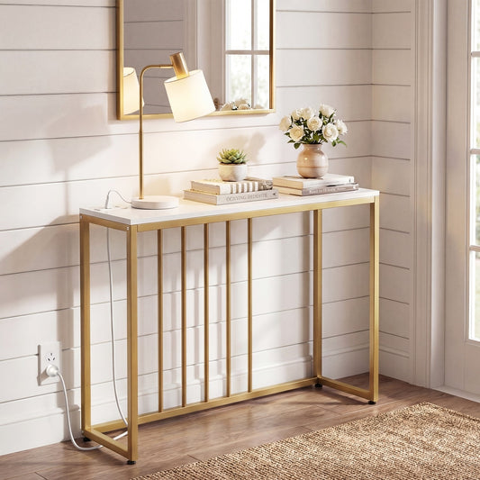 White console table with gold legs and charging station in a hallway setting