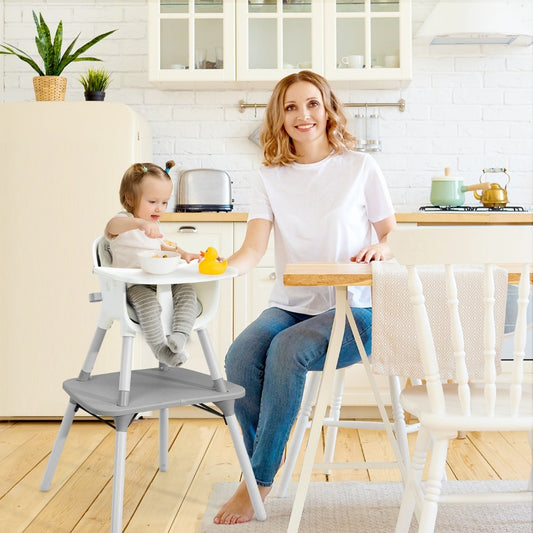The grey high chair in use with a baby and mother in a kitchen setting