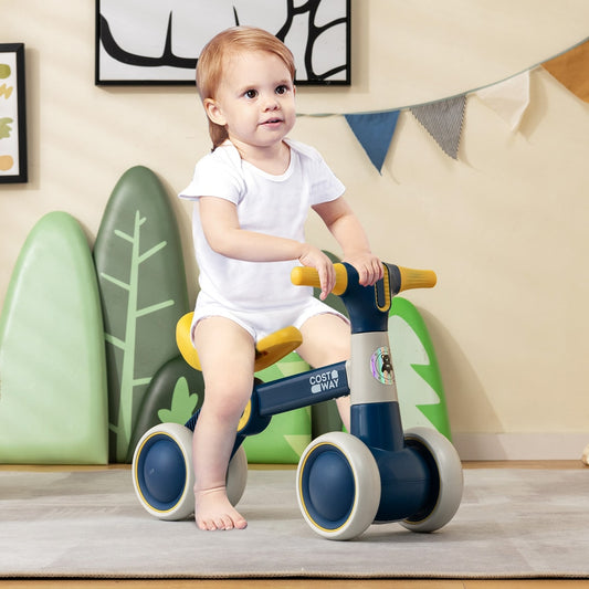 The balance bike being used by a toddler in a nursery with soft play decorations