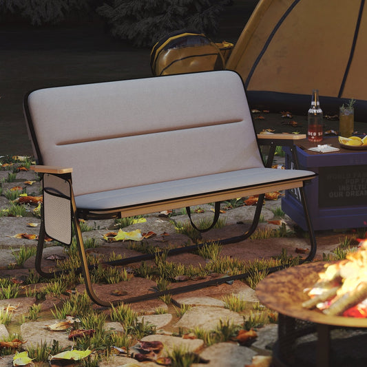 The grey two-person camping chair set up on grass next to a tent