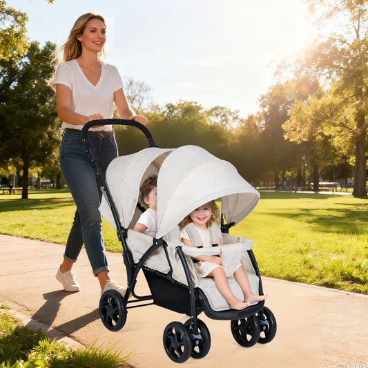 Woman pushing a beige double pushchair with two babies sitting in it on a sunny path