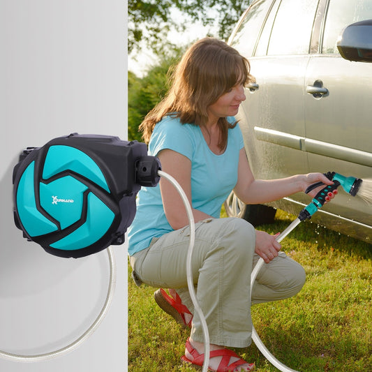 The wall mounted hose reel is shown in use by a woman watering a car