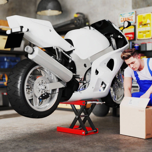 A white motorbike is lifted on a red scissor jack stand in a garage setting