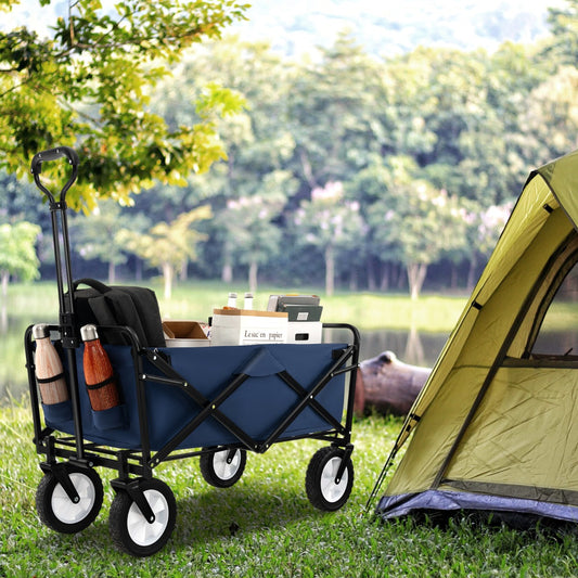 The camping furniture standing on green grass next to a tent in a woodland setting