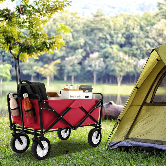 Red camping cart being used next to a tent by a lake